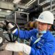 Photo of Mr Haiyang Chen, rolling mill worker at the Hebei Jinxi Iron & Steel Group in China, at his daily work in the rolling mill with protective equipment.